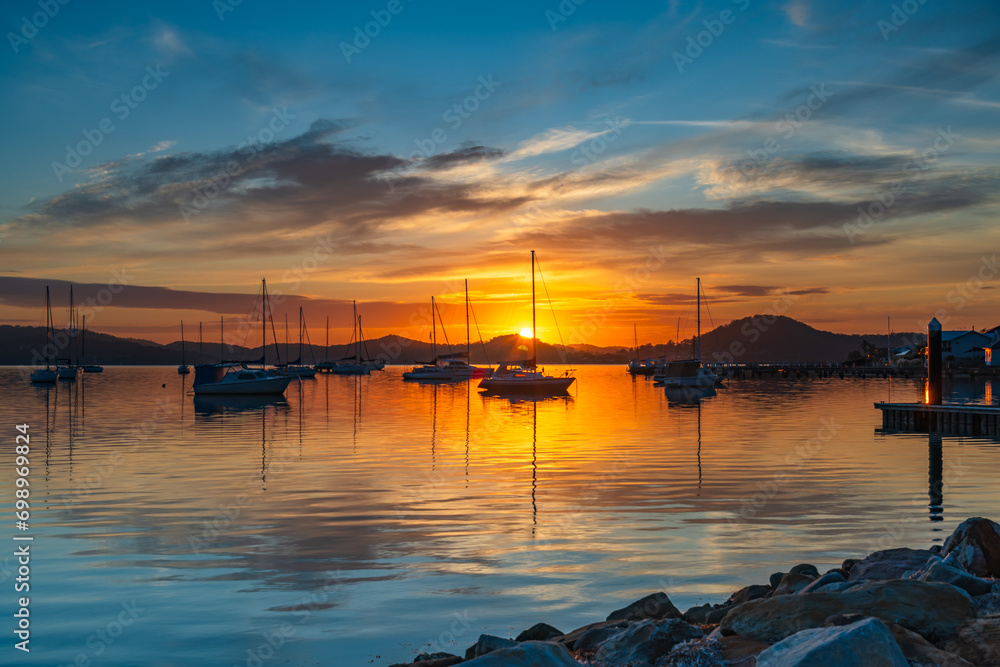 Sunrise, boats and reflections on the water