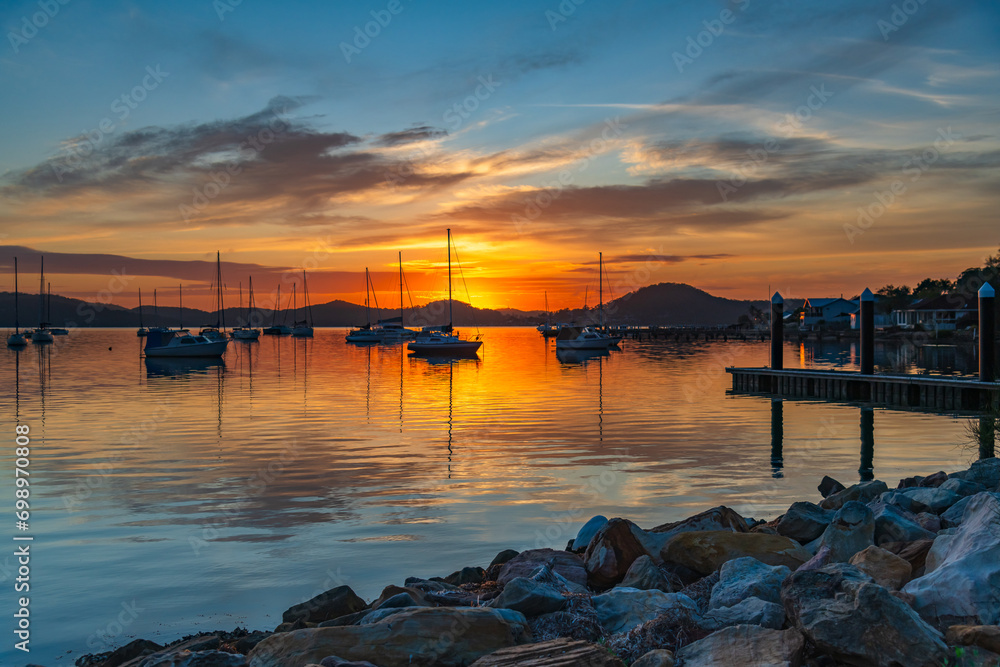 Sunrise, boats and reflections on the water