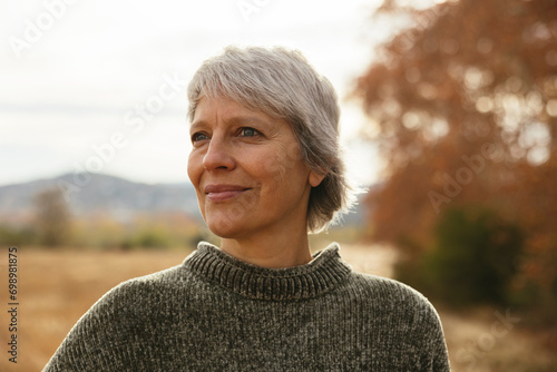 Smiling mature woman wearing sweater photo