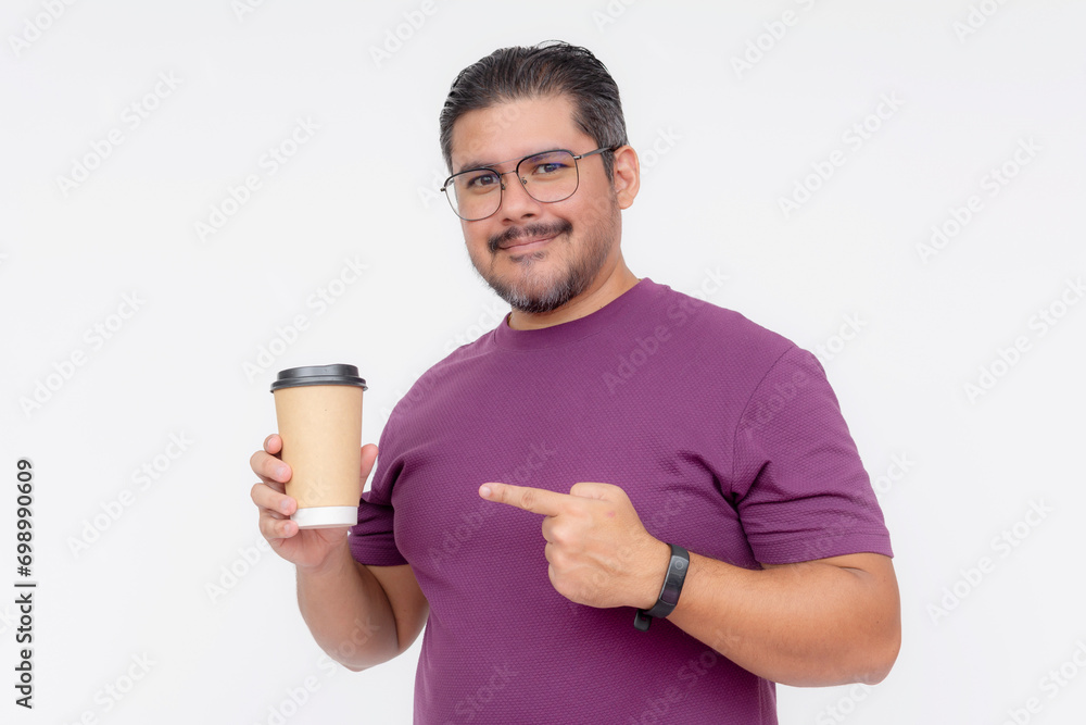 Action shot of a middle aged man pointing to a cup of coffee. Wearing a purple waffle shirt and jeans.Half body shot, isolated on a white background. Action shot of a middle aged man pointing to a cup of coffee. Wearing a purple waffle shirt and jeans.Half body shot, isolated on a white background.