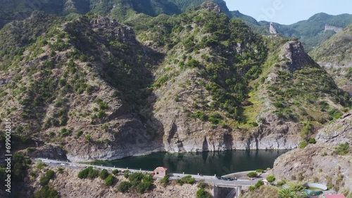 Damm with water reservoir in a rocky valley at the canary islands, la gomera