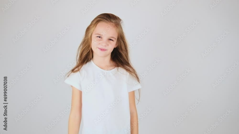 Beautiful preteen girl posing on camera isolated on white background. Young model in studio Stock ビデオ | Adobe Stock