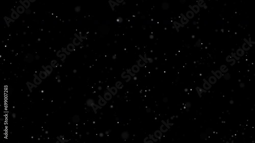 White snow bokeh falling overlay on black background. abstract dust particles snowflakes and snowfall slowly falling motion effect for christmas holiday festival. Luxury decorative element. photo
