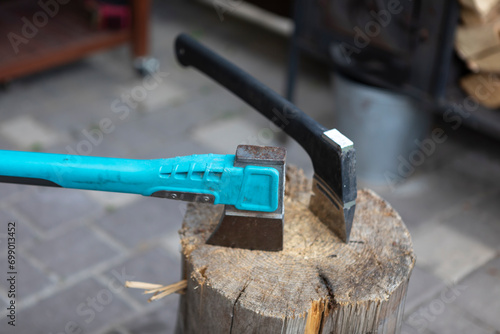 Two axes stand side by side, their sharp blades glinting in the light, ready for use in the hands of a skilled outdoorsman