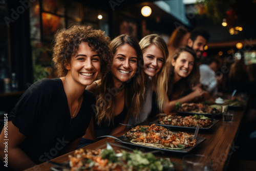 Group of happy friends taking selfie while celebrating in restaurant