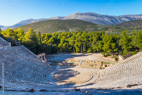 Ancient Theatre of Epidaurus is theatre in Greek city of Epidaurus, located on southeast end of sanctuary dedicated to the ancient Greek God of medicine, Asclepius in Peloponnese, Greece photo