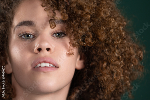 close up portrait of beautiful young woman with curly hair 