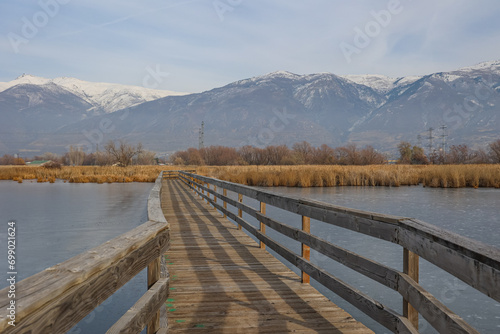 Wooden boardwalk crosses wetlands in Utah's Farmington Bay Wildlife Management Area.