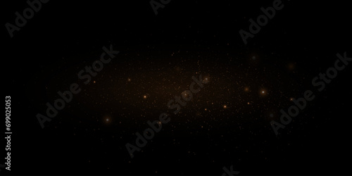 Golden glitter. Flare light effect. Shiny background of particles and light. Gold dust on a black background. photo