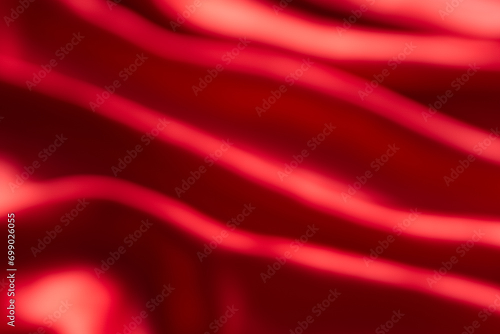 Obraz premium The bright red silk satin surface is beautiful and luxurious, wavy. For background and graphic work Blurry or blurry