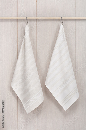 Kitchen towels hanging on wooden background © Lorenzo