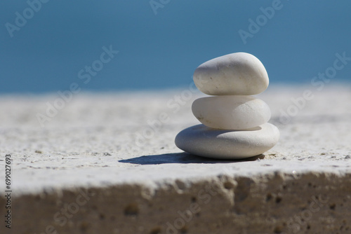  Three white pyramid of stones for meditation lying on sea coast