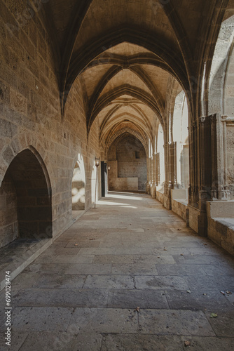Interior corridor in ancient landmark building with gothic arch in a medieval architecture in Narbonne