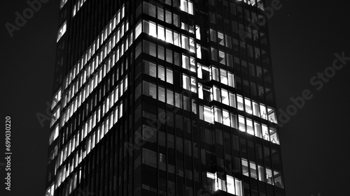 Wallpaper Mural Pattern of office buildings windows illuminated at night. Glass architecture ,corporate building at night - business concept. Black and white. Torontodigital.ca