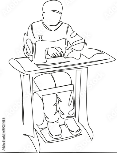 male tailor sews on a sewing machine