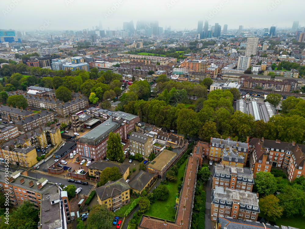 Obraz premium Top cinematic aerial view to the London streets. Drone footage. Flight over London - amazing view over the rooftops - travel videography. Establishing Aerial View Shot of London UK, United Kingdom