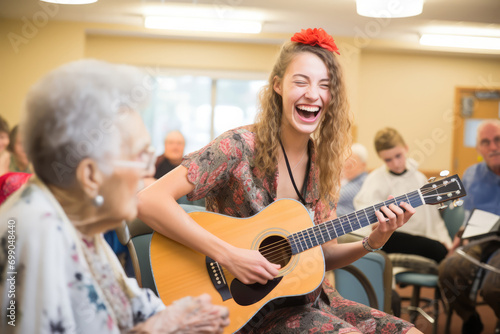 Volunteer Engages With Residents Through Reading Or Playing Music In Nursing Home photo