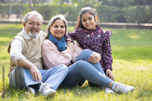 Photography Portrait of happy granddaughter embracing loving grandparents