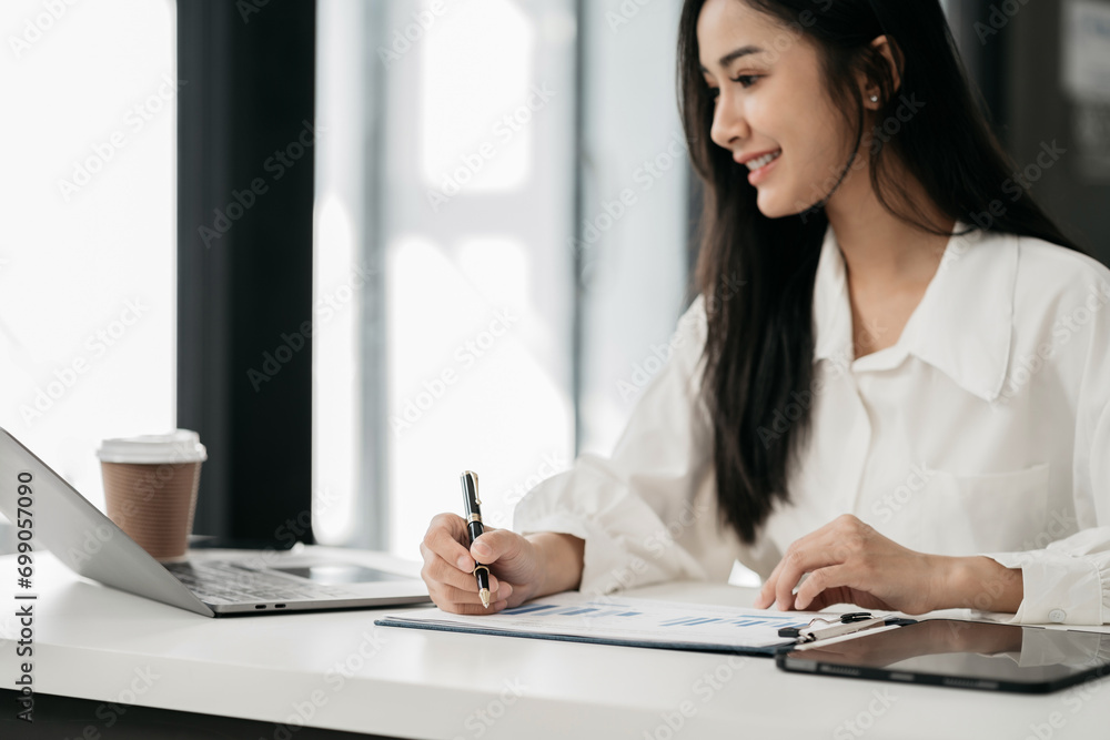 Business documents on office desk with laptop and smart phone and graph business diagram and man working at office. Business documents on office desk with laptop and smart phone and graph business diagram and man working at office.