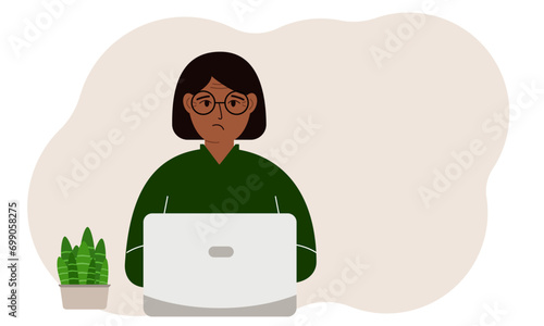 A woman is working or studying at a laptop. Freelancing or distance learning and work concept.