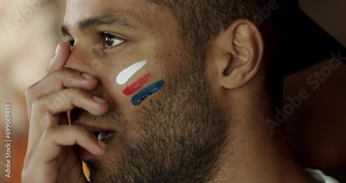Soccer fan is disappointed with the loss of the team in the sports bar, Loyal soccer fan supporting their team. USA supporter. Unhappy mixed race supporter. Man with USA national country flag. photo