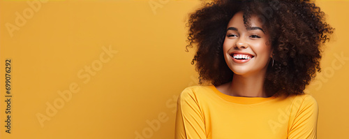 Smiling woman with afro hairs on color background. copy space for text.