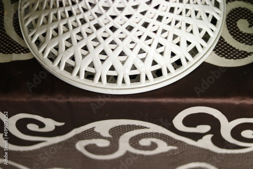 A white colored Damroo or damru plastic stool on a bench, closeup photo