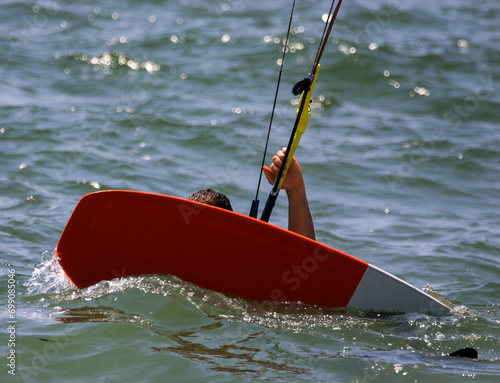 A Person Riding a Kite Board on Top of a Body of Water photo