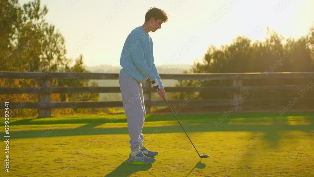 Golf game a golfer hits the ball in the sunlight. People, sport, leisure activity, recreation and lifestyle, man hitting ball with club in golf course Golf game a golfer hits the ball in the sunlight. People, sport, leisure activity, recreation and lifestyle, man hitting ball with club in golf course