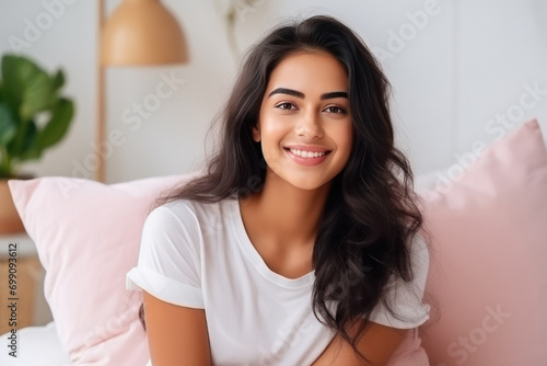 young indian woman relaxing on bed at home