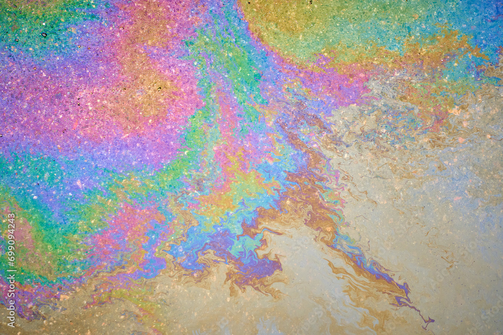 Fuel or oil stains on an asphalt road as a texture or background