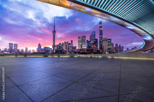 Empty square floor and bridge with modern city buildings scenery in Shanghai at sunrise