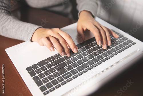 Business woman hands typing on laptop computer keyboard