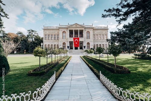 Dolmabahce sarayi palace in Besiktas Istanbul. Fasade with national turkish flag. photo