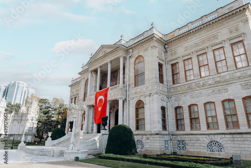 Dolmabahce sarayi palace in Besiktas Istanbul. Fasade with national turkish flag. photo