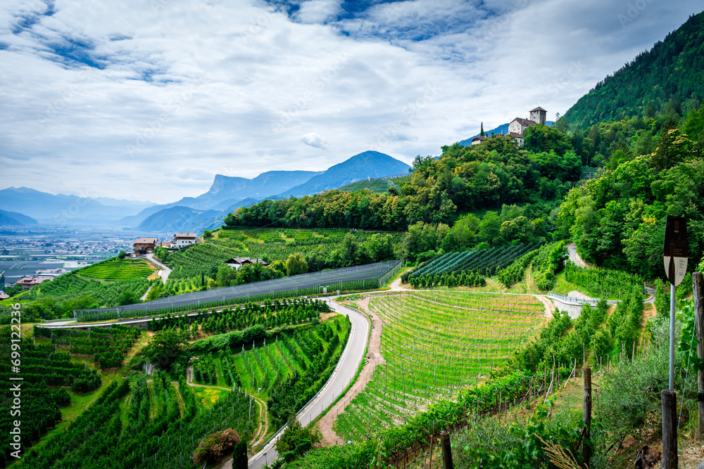 Hiking along the Marlinger Waalweg near Meran in South Tyrol Italy. With some Views over wineyards, the City of Meran, Marling and other Villages - obrazy, fototapety, plakaty 