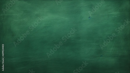 Old green chalkboard texture background, closeup of green grunge textured background with scratches and scuffs photo