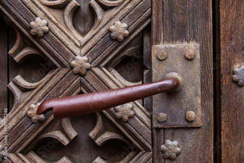 antique iron handle on the background of a wooden door