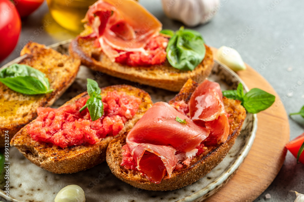 Toast with tomato and Olive oil and jamon ham, traditional Spanish breakfast Toast with tomato and Olive oil and jamon ham, traditional Spanish breakfast
