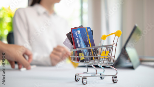 Credit card are popularly used today era because they are convenient for purchasing products from regular stores and online stores can purchase products through application by paying with credit card. photo