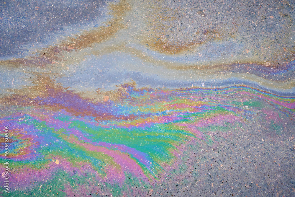 Fuel or oil stains on an asphalt road as a texture or background