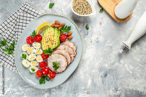 boiled quail eggs with avocado, chicken fillet roll and cherry tomatoes, Healthy Breakfast on a light background, banner, menu, recipe place for text, top view