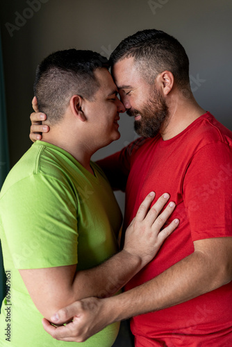 vertical portrait of a lgbt couple of happy men hugging each other with their heads together © LEONARDO BORGES