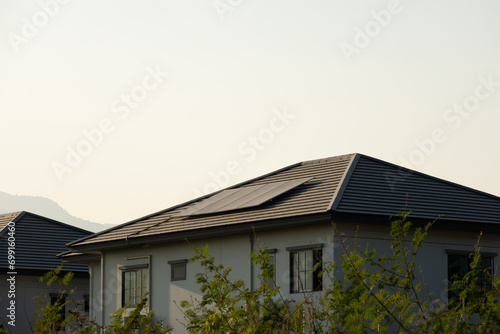 Sustainable Energy Solution: Solar Panels on House Rooftop Generating Clean Power in Urban Environment