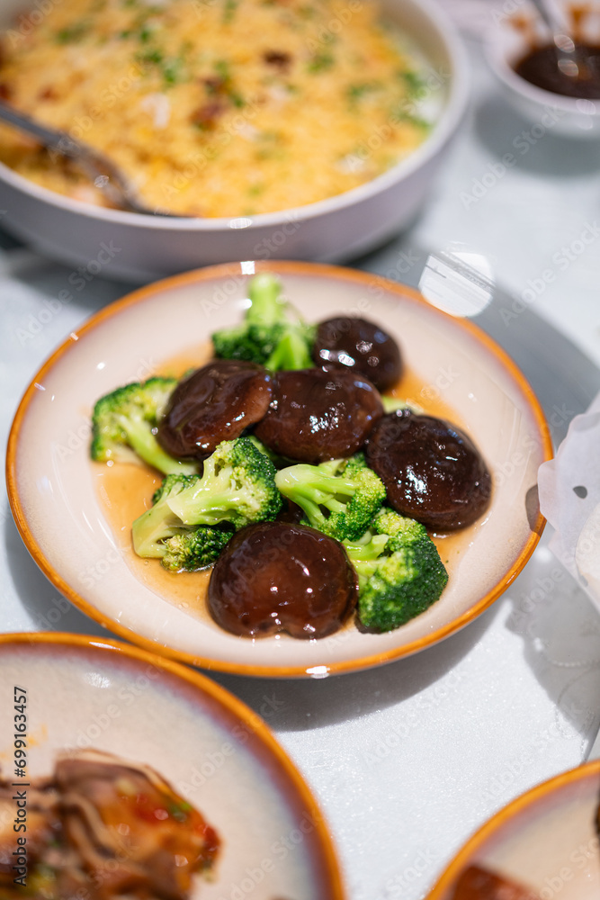 Shiitake mushroom mixed broccoli vegetable stir-fired with oyster sauce, Chinese food menu that served in ceramic dish. Food object photo, close-up. Shiitake mushroom mixed broccoli vegetable stir-fired with oyster sauce, Chinese food menu that served in ceramic dish. Food object photo, close-up.