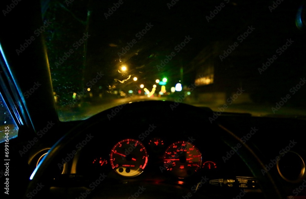 Driving on a dark roadway in an automobile Driving on a dark roadway in an automobile