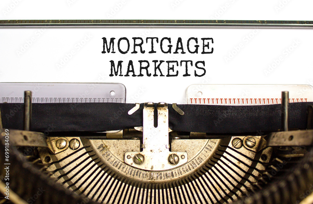 Mortgage markets symbol. Concept words Mortgage markets typed on beautiful old retro typewriter. Beautiful white paper background. Business mortgage markets concept. Copy space.