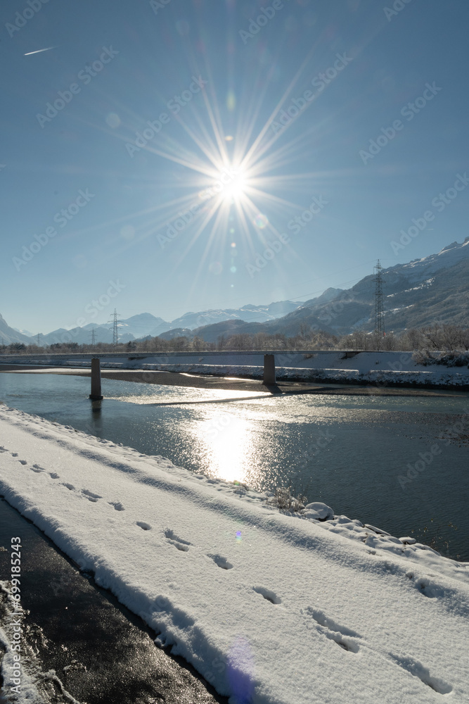Snow covered landscape panorama at the rhine river in Vaduz in Liechtenstein Snow covered landscape panorama at the rhine river in Vaduz in Liechtenstein