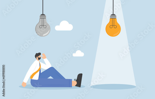 Failure from using wrong idea, ineffective solution, misguided decisions concept, Frustrated businessman under the dark and broken light bulb.

