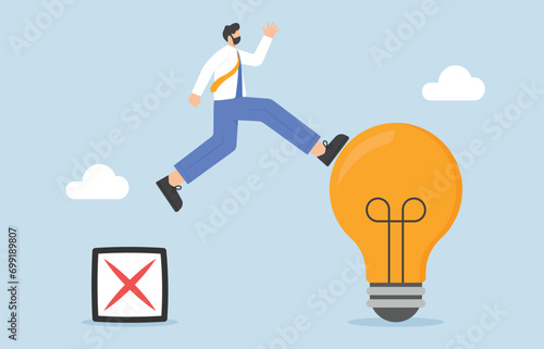 Learn from mistake, gain knowledge or experience from failure concept, Businessman jumping from cross sign up to light bulb.

